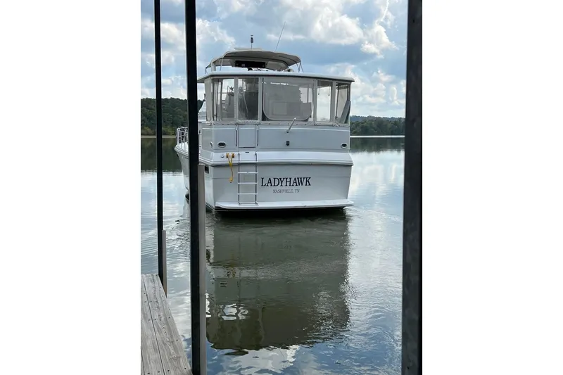 Slide: The Image of 1987 Carver 42 Aft Cabin Motor Yacht "Ladyhawk" docked on calm water. - 5