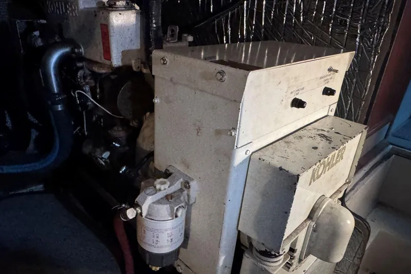 Slide: The Image of Engine room of 1987 Carver 42 Aft Cabin Motor Yacht with visible machinery components. - 50