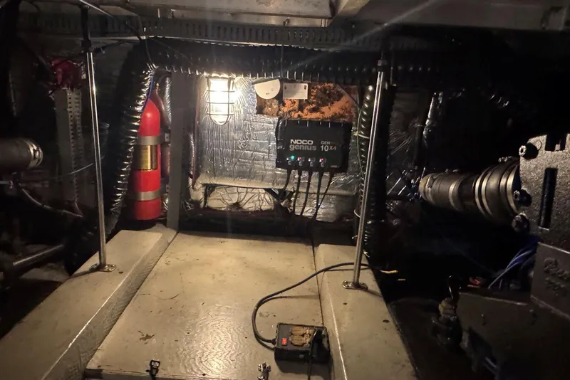 Slide: The Image of Engine room of 1987 Carver 42 Aft Cabin Motor Yacht with NOCO Genius charger. - 54