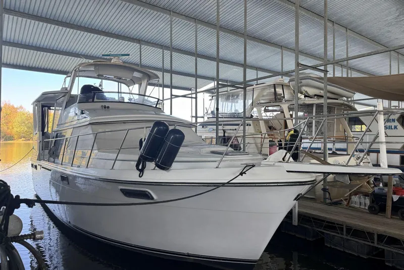 Slide: The Image of 1987 Carver 42 Aft Cabin Motor Yacht docked in a covered marina. - 6