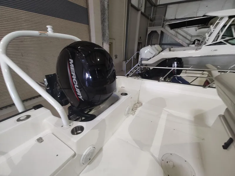 Slide: The Image of 2022 Boston Whaler 190 Montauk with Mercury outboard engine in a storage facility. - 17