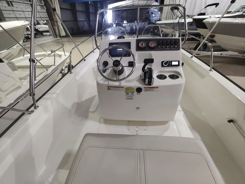 Slide: The Image of 2022 Boston Whaler 190 Montauk boat interior with steering console and seating. - 23