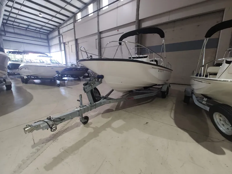 Slide: The Image of 2022 Boston Whaler 190 Montauk boat on trailer in indoor storage facility. - 3