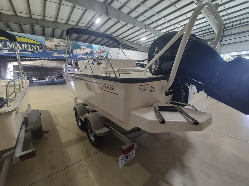 Slide: The Image of 2022 Boston Whaler 190 Montauk boat in showroom, rear view with trailer. - 4