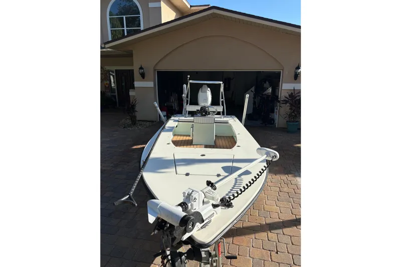 Slide: The Image of 2019 Skimmer Skiff 16'6" CC boat cruising on a calm river. - 10