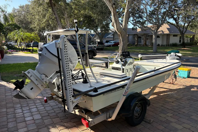 Slide: The Image of 2019 Skimmer Skiff 16'6" CC boat cruising on open water, aerial view. - 2