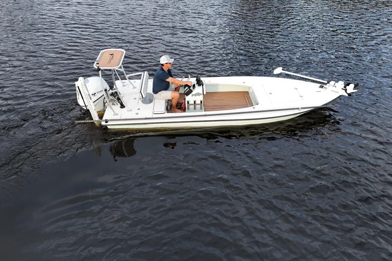 Slide: The Image of 2019 Skimmer Skiff 16'6" CC boat on water with driver. - 27