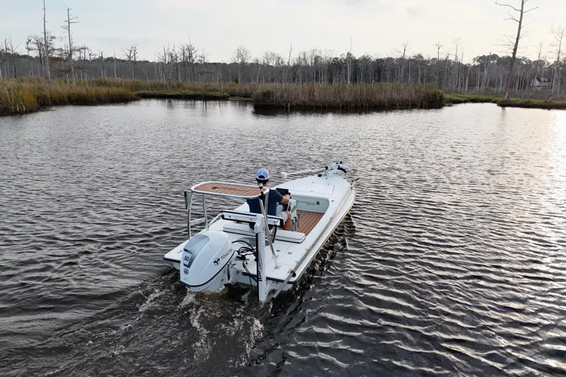 Slide: The Image of 2019 Skimmer Skiff 16'6" CC navigating through serene marshland waters. - 31
