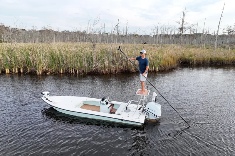 Slide: The Image of 2019 Skimmer Skiff 16'6" CC boat with person poling in marshland. - 32