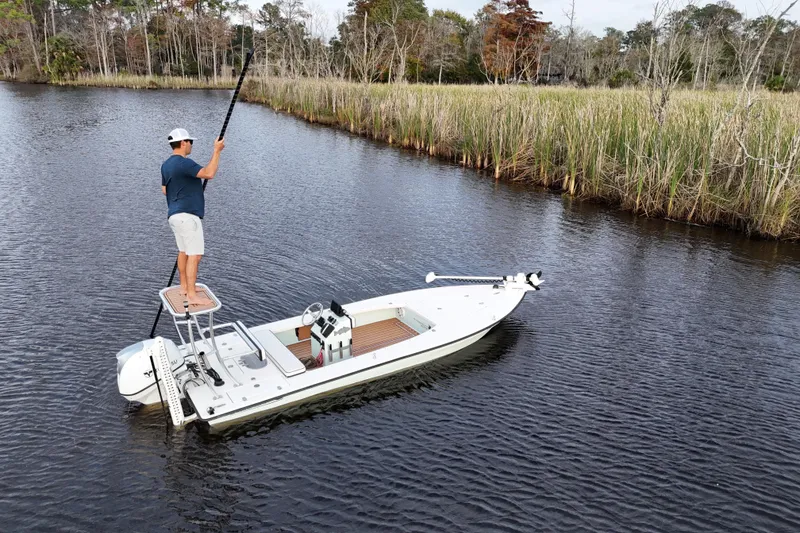 Slide: The Image of Man on 2019 Skimmer Skiff 16'6" CC boat in calm waters near reeds. - 35
