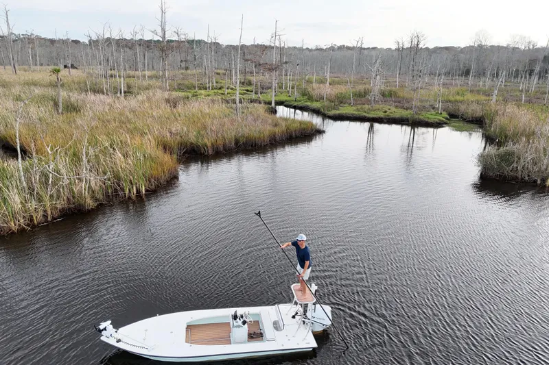 Slide: The Image of Man on 2019 Skimmer Skiff 16'6" CC boat in marshland. - 36