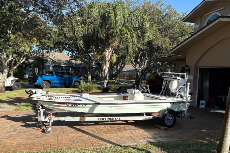 Slide: The Image of 2019 Skimmer Skiff 16'6" CC boat on trailer in residential driveway. - 37