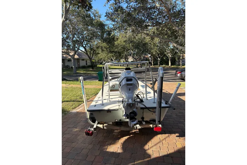 Slide: The Image of 2019 Skimmer Skiff 16'6" CC boat on driveway, surrounded by trees. - 43