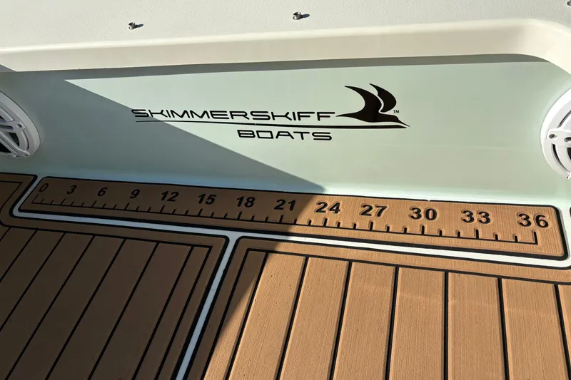 Slide: The Image of 2019 Skimmer Skiff 16'6" CC boat deck with logo and measurement scale. - 44
