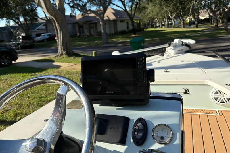 Slide: The Image of 2019 Skimmer Skiff 16'6" CC boat dashboard with Garmin GPS and steering wheel. - 45
