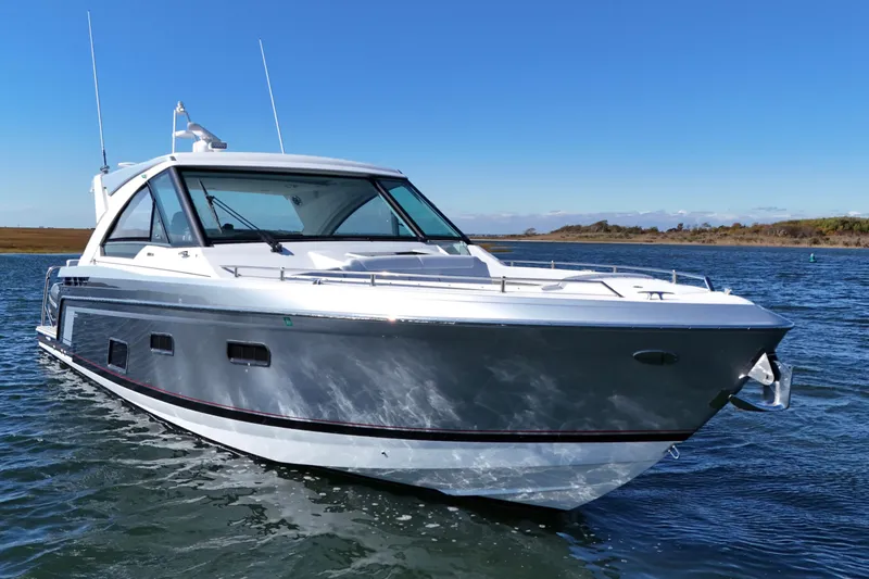 Slide: The Image of 2021 Formula 400 Super Sport Crossover yacht on calm water under clear blue sky. - 11