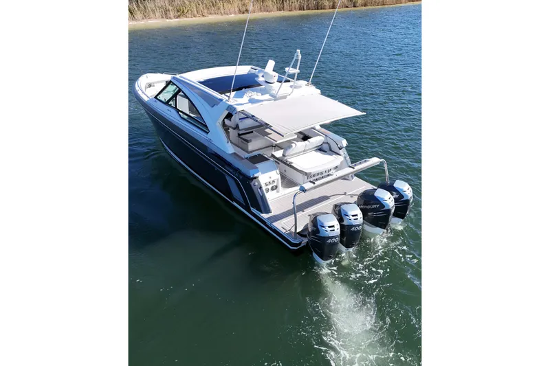 Slide: The Image of 2021 Formula 400 Super Sport Crossover boat with triple Mercury engines on water. - 13