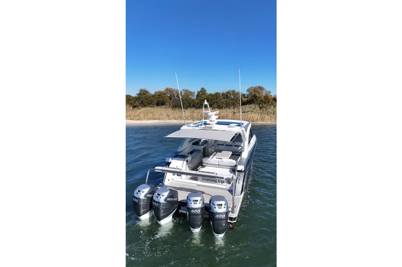 Slide: The Image of 2021 Formula 400 Super Sport Crossover boat with four engines on water. - 14