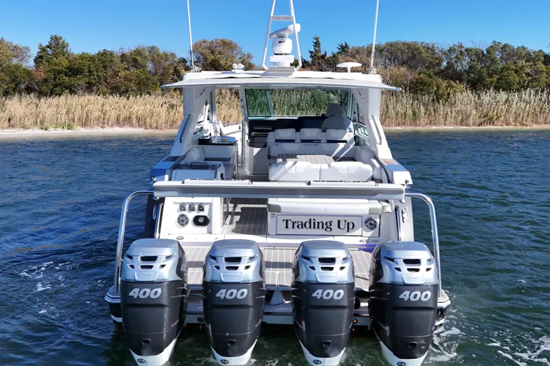 Slide: The Image of 2021 Formula 400 Super Sport Crossover boat with four powerful engines on a serene lake. - 15