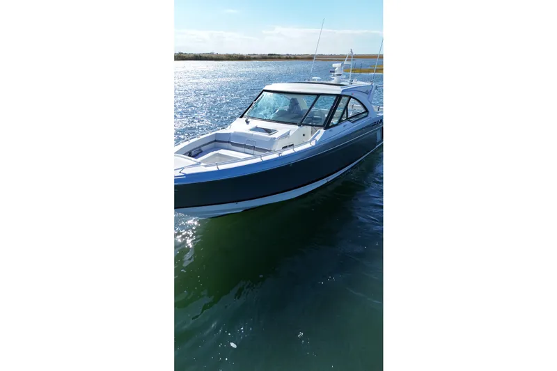 Slide: The Image of 2021 Formula 400 Super Sport Crossover boat on calm water, sunny day. - 20