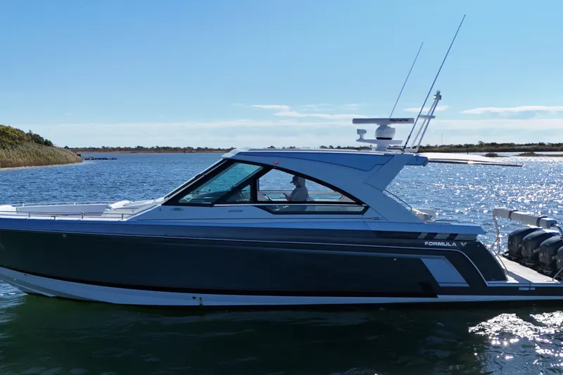 Slide: The Image of 2021 Formula 400 Super Sport Crossover boat on a sunny lake. - 25