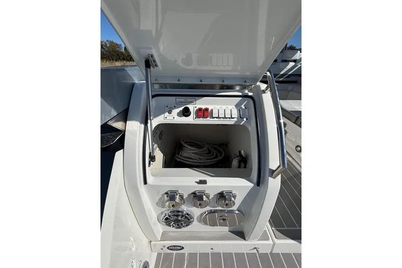 Slide: The Image of 2021 Formula 400 Super Sport Crossover boat control panel with open storage compartment. - 33
