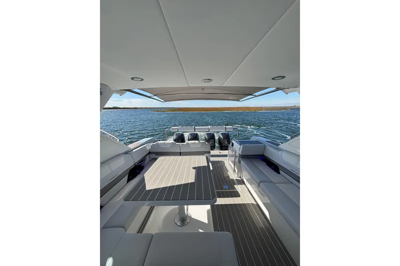 Slide: The Image of 2021 Formula 400 Super Sport Crossover boat interior with seating and table, overlooking water. - 41