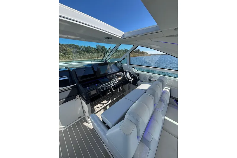 Slide: The Image of Luxurious interior of 2021 Formula 400 Super Sport Crossover boat with modern dashboard and seating. - 45