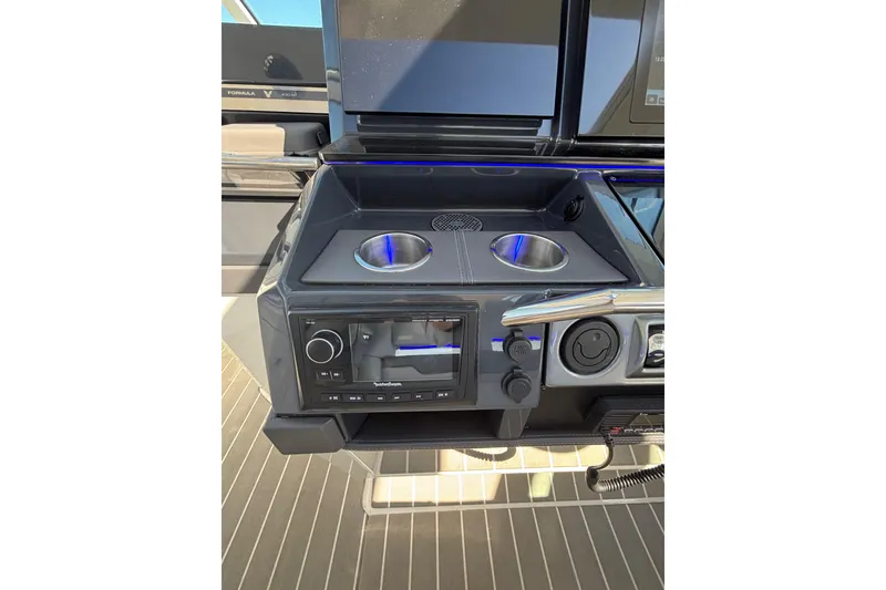 Slide: The Image of Control panel of 2021 Formula 400 Super Sport Crossover with cup holders and audio system. - 53