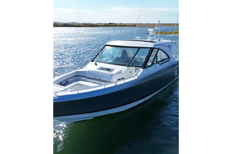 Slide: The Image of 2021 Formula 400 Super Sport Crossover boat on calm water, sunny day. - 7