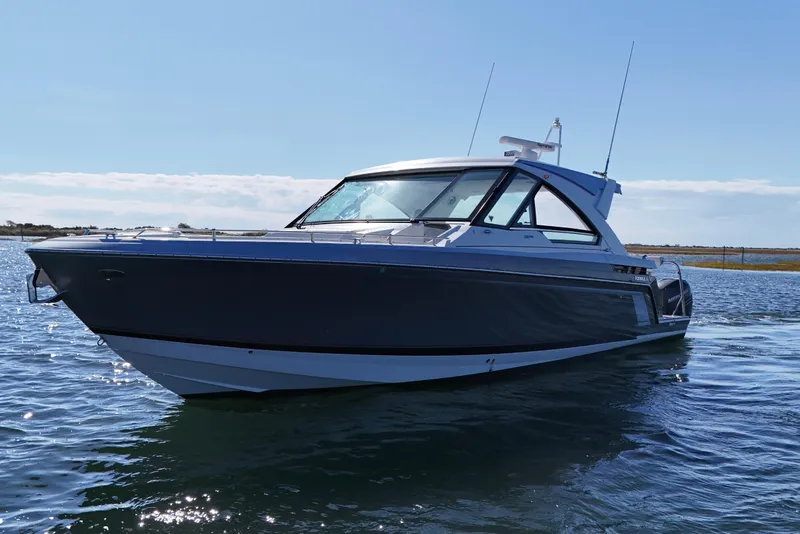 Slide: The Image of 2021 Formula 400 Super Sport Crossover boat on calm water under clear sky. - 9