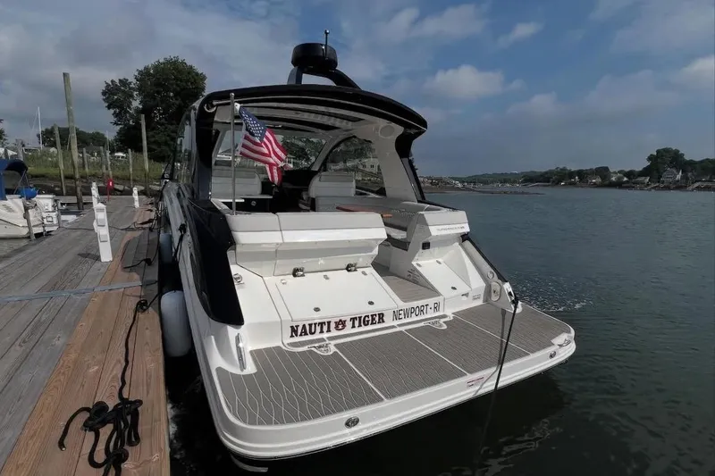 Slide: The Image of 2024 Sea Ray Sundancer 370 engine compartment, showcasing modern design and powerful engines at a marina. - 18