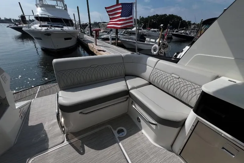 Slide: The Image of 2024 Sea Ray Sundancer 370 helm with modern controls and luxurious seating. - 20