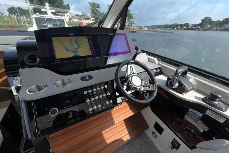 Slide: The Image of 2024 Sea Ray Sundancer 370 helm controls with joystick and throttle. - 23