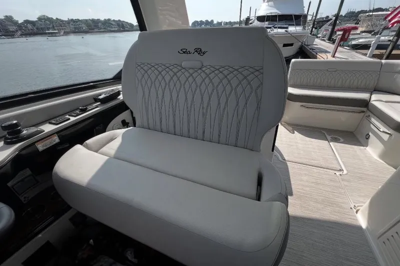 Slide: The Image of 2024 Sea Ray Sundancer 370 luxury yacht with spacious deck seating at marina. - 24