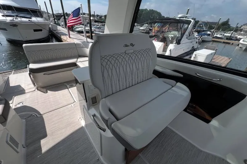 Slide: The Image of 2024 Sea Ray Sundancer 370 with spacious bow seating at a marina. - 25