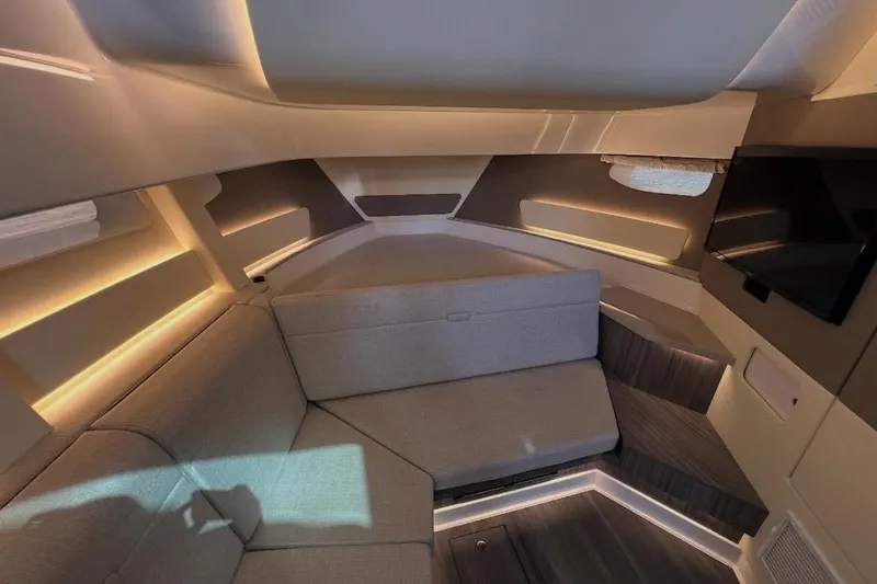 Slide: The Image of 2024 Sea Ray Sundancer 370 boat with elegant seating and wooden table on deck. - 27