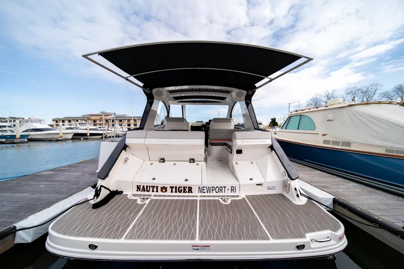 Slide: The Image of 2024 Sea Ray Sundancer 370 docked, showcasing spacious deck and sleek design. - 8