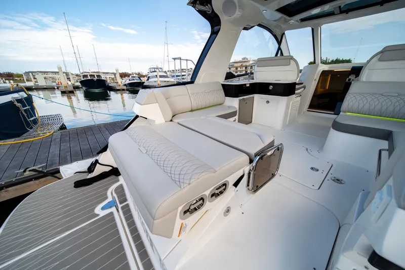 Slide: The Image of 2024 Sea Ray Sundancer 370 yacht interior with luxurious seating at marina. - 9