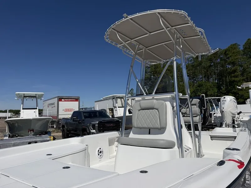 Slide: The Image of 2026 Blazer PureBay 2200 boat with T-top in parking lot. - 22