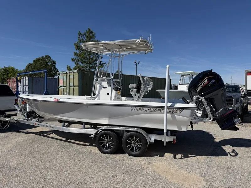 Slide: The Image of 2026 Blazer PureBay 2200 boat on trailer outdoors. - 7