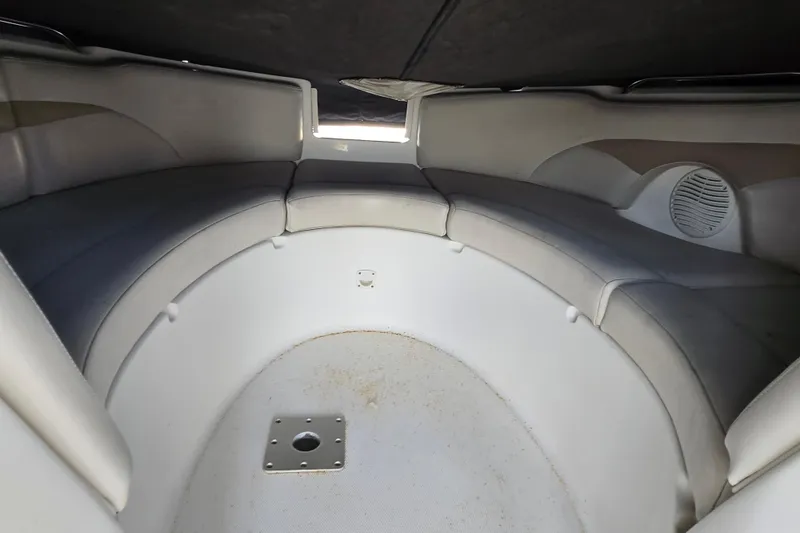 Slide: The Image of 2003 Chaparral Sunesta 233 boat interior with curved seating and speaker. - 10