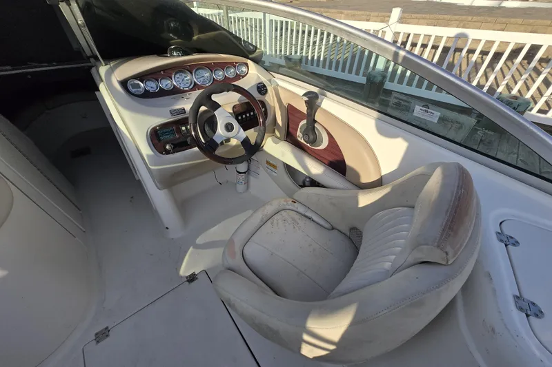 Slide: The Image of 2003 Chaparral Sunesta 233 boat interior with steering wheel and control panel. - 3