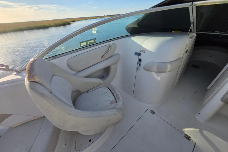 Slide: The Image of 2003 Chaparral Sunesta 233 boat interior with seating and water view. - 6
