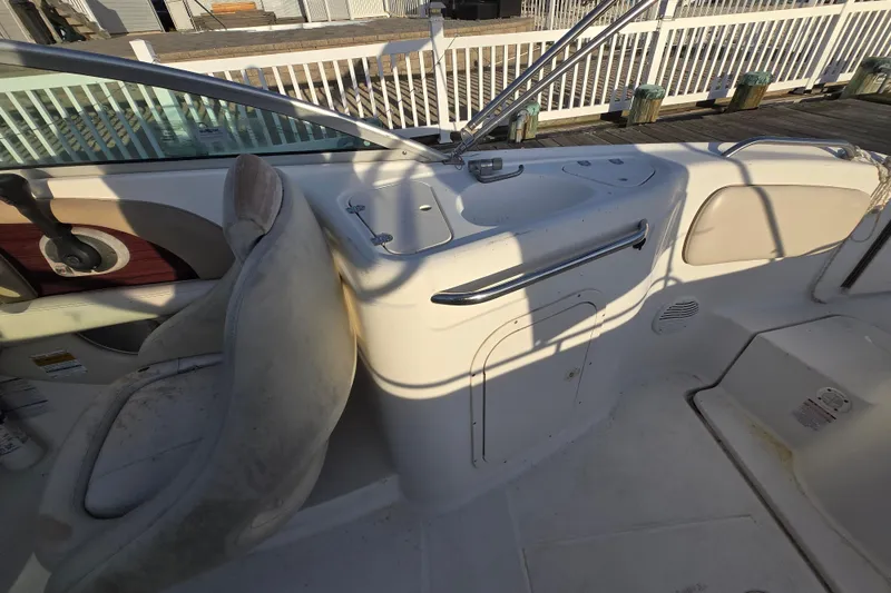 Slide: The Image of 2003 Chaparral Sunesta 233 boat interior with seating and control panel. - 7