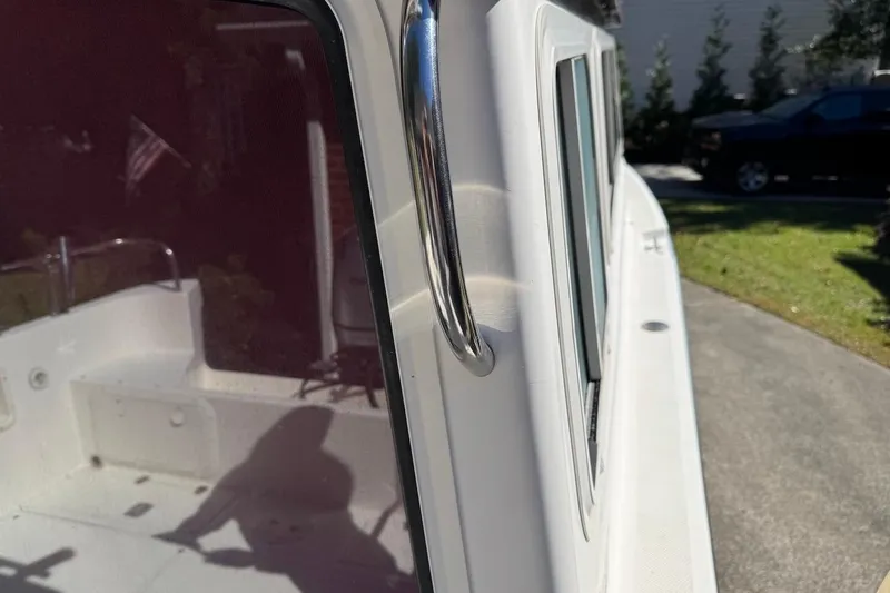 Slide: The Image of 2007 C-Dory 25 Pilothouse boat exterior with chrome handle and windows. - 10