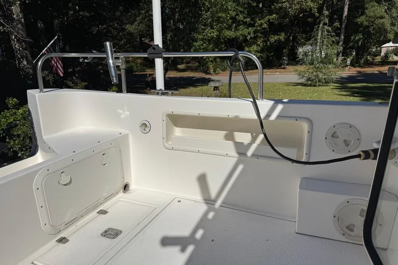 Slide: The Image of 2007 C-Dory 25 Pilothouse boat interior with storage compartments and railing. - 13