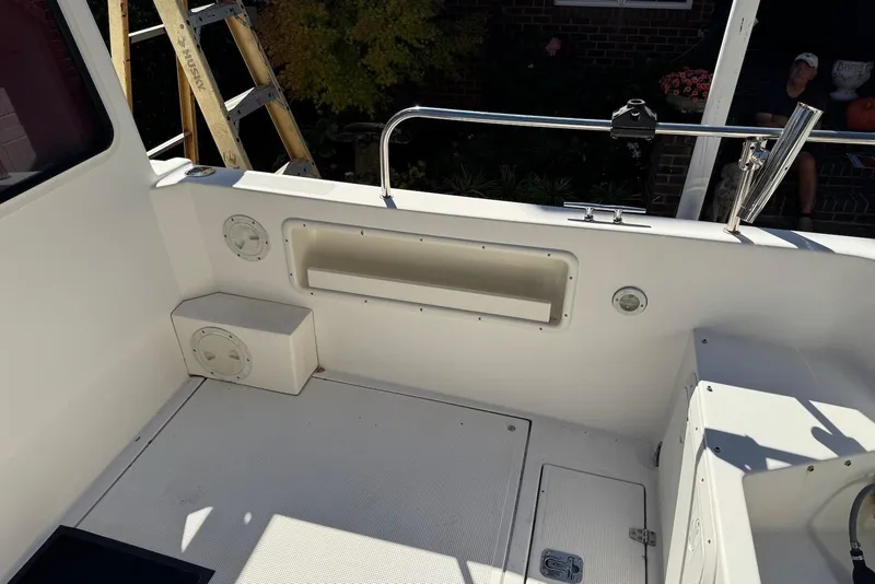 Slide: The Image of 2007 C-Dory 25 Pilothouse boat interior with storage compartments and railing. - 14