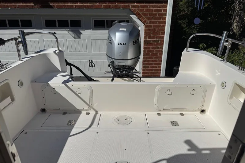 Slide: The Image of 2007 C-Dory 25 Pilothouse boat with Honda 150 outboard motor in a garage. - 15