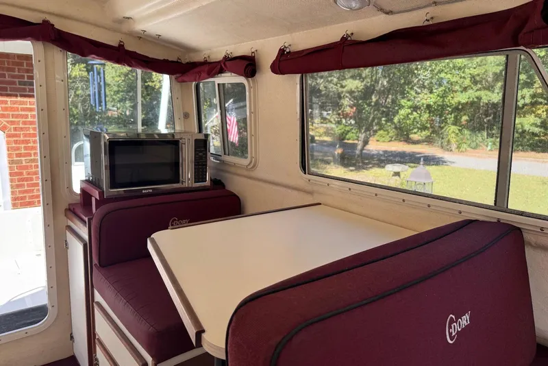 Slide: The Image of Interior of 2007 C-Dory 25 Pilothouse with dining area and microwave. - 19